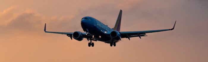 a large jetliner flying through a cloudy sky